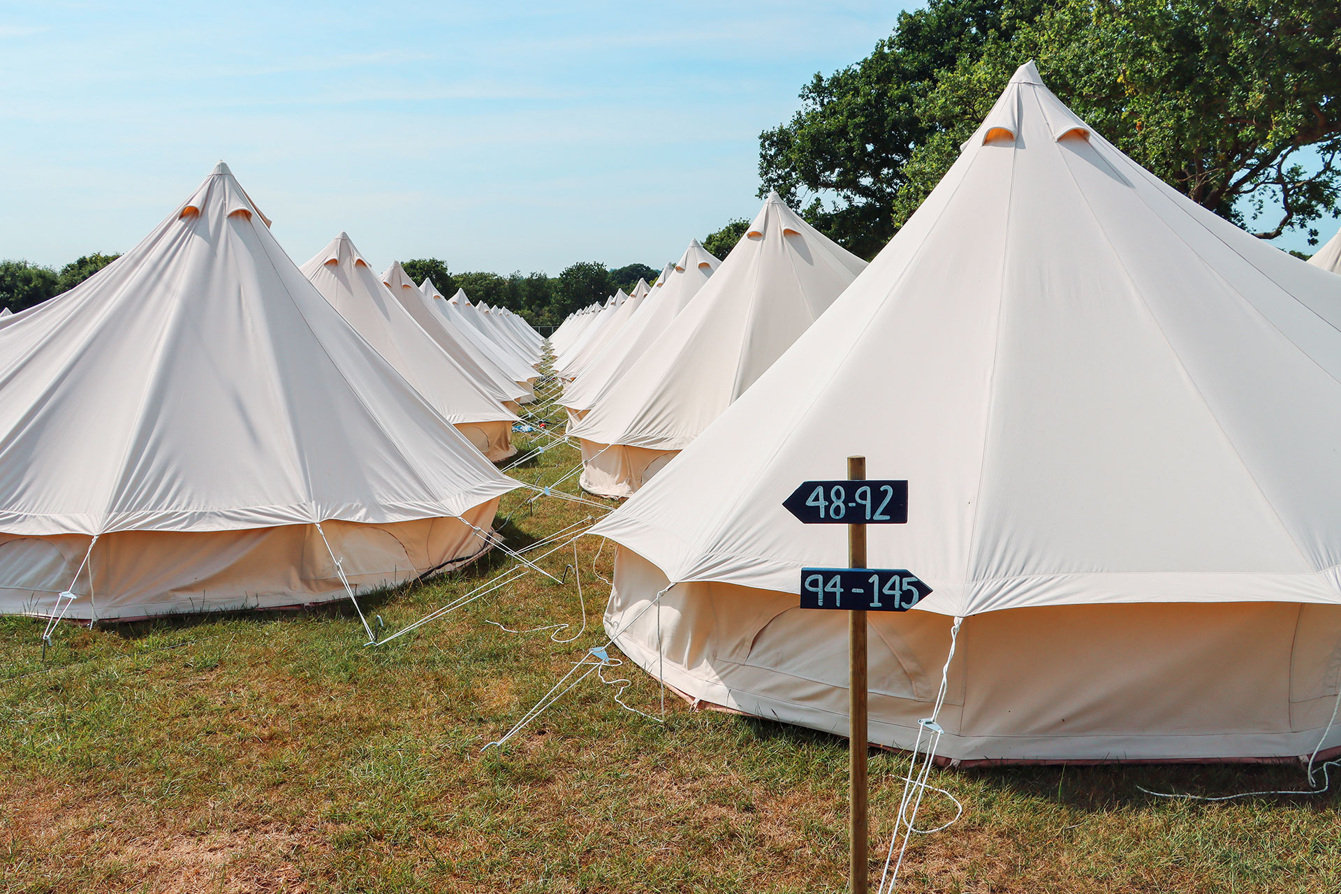 Row of tents with labelled signage